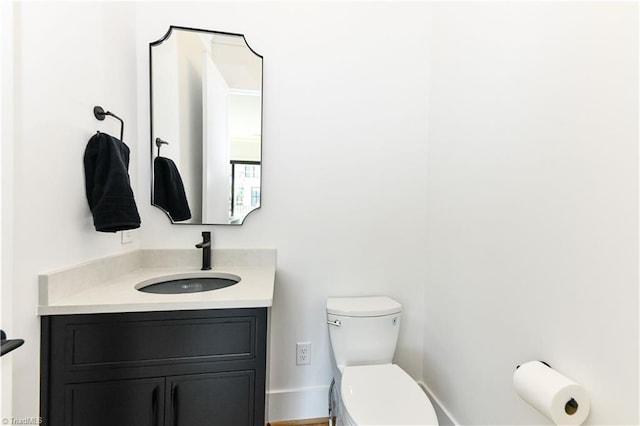 bathroom with toilet and vanity