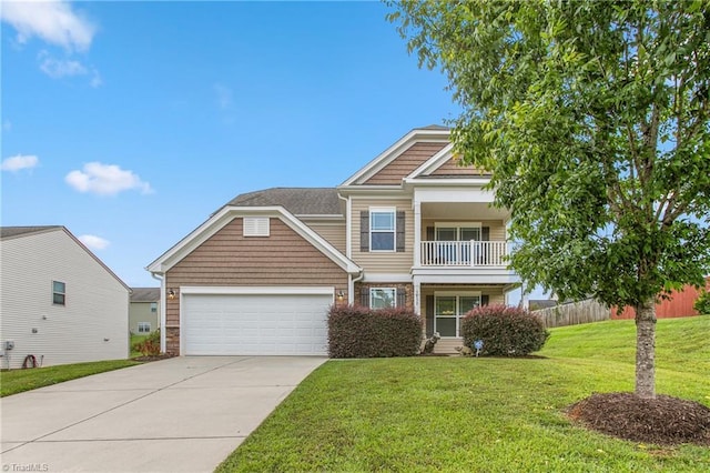 traditional-style home featuring a balcony, fence, an attached garage, concrete driveway, and a front yard