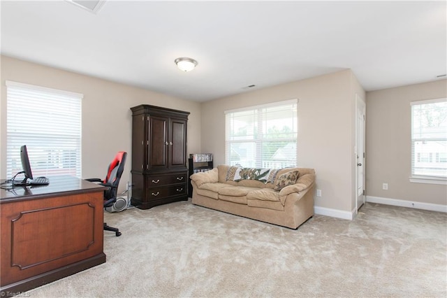 office with light colored carpet and baseboards