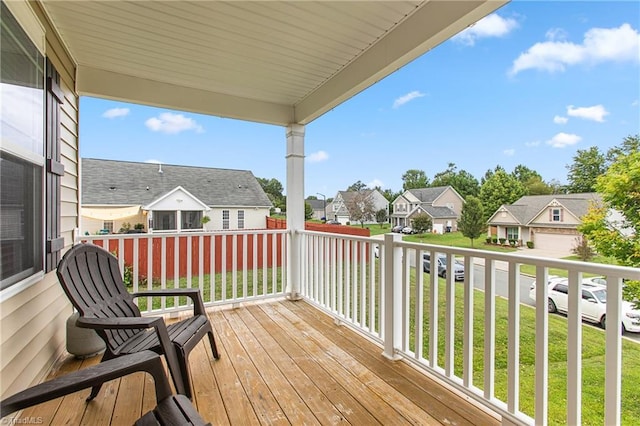 wooden terrace with a lawn and a residential view