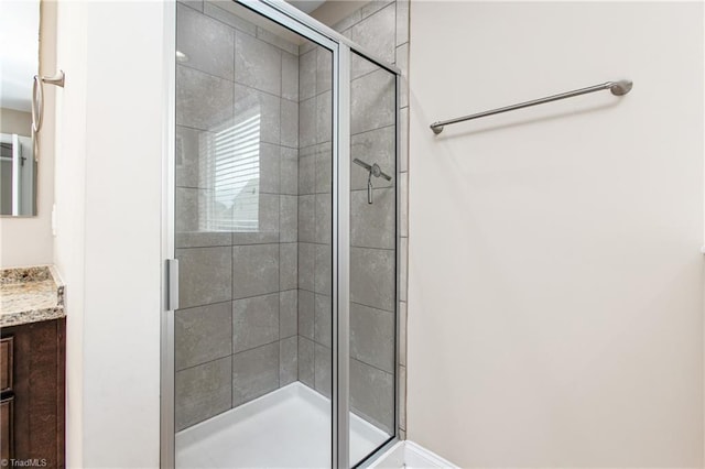 bathroom with a stall shower and vanity