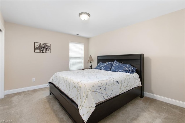 bedroom with carpet and baseboards