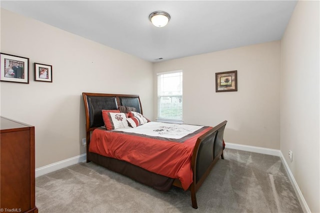 carpeted bedroom featuring baseboards