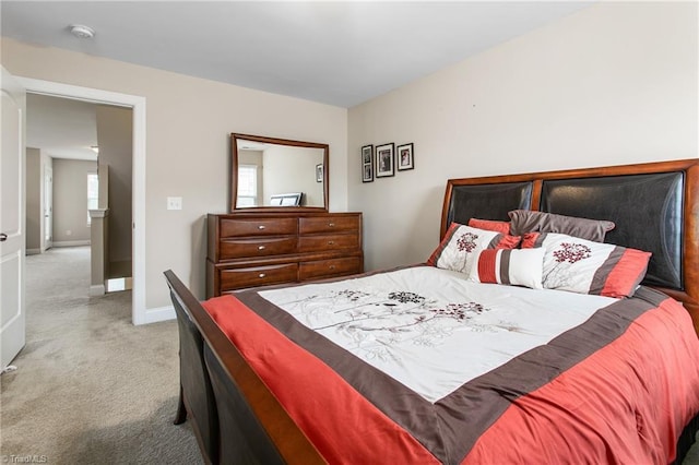 bedroom featuring carpet and baseboards