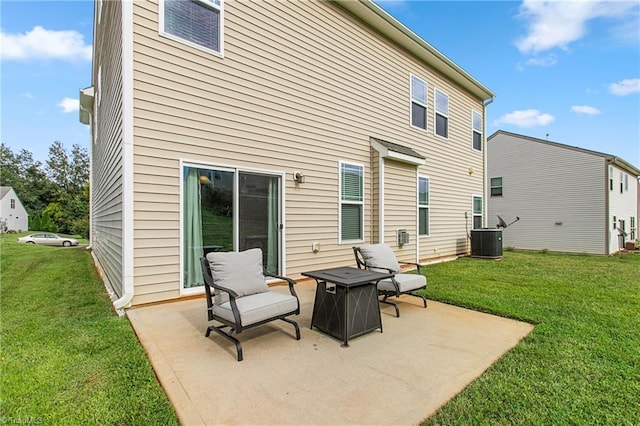rear view of property with cooling unit, a patio area, and a lawn