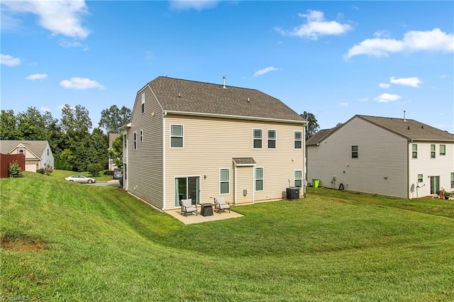 rear view of property featuring a lawn, a patio area, and central AC