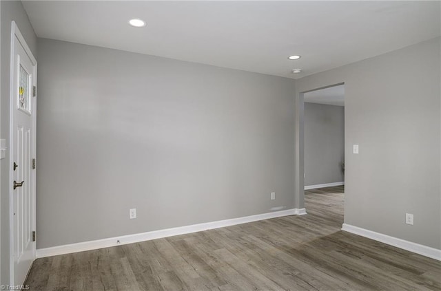 unfurnished room with hardwood / wood-style flooring