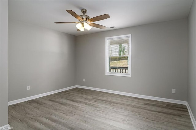 empty room featuring ceiling fan and light hardwood / wood-style floors