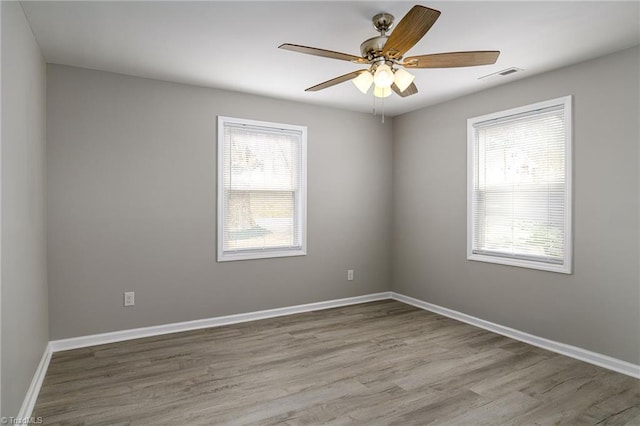 unfurnished room with light hardwood / wood-style flooring and ceiling fan