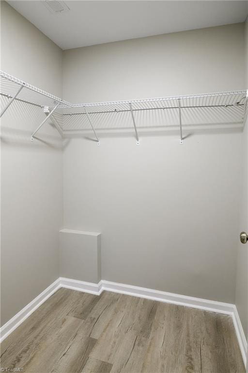 walk in closet featuring hardwood / wood-style flooring