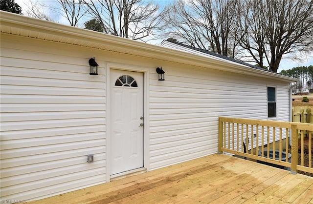 view of exterior entry featuring a deck