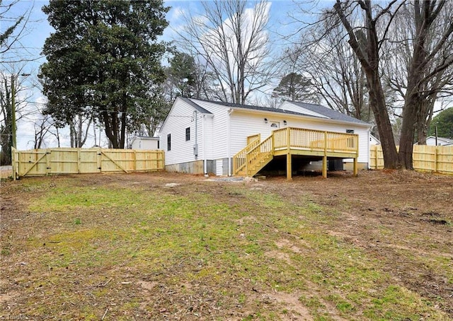 rear view of property with a yard and a deck