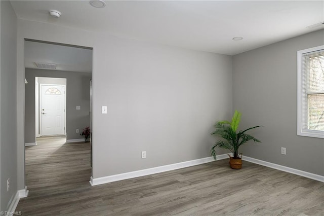 unfurnished room with hardwood / wood-style flooring