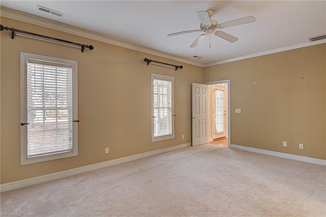 unfurnished room featuring light carpet, ceiling fan, and crown molding