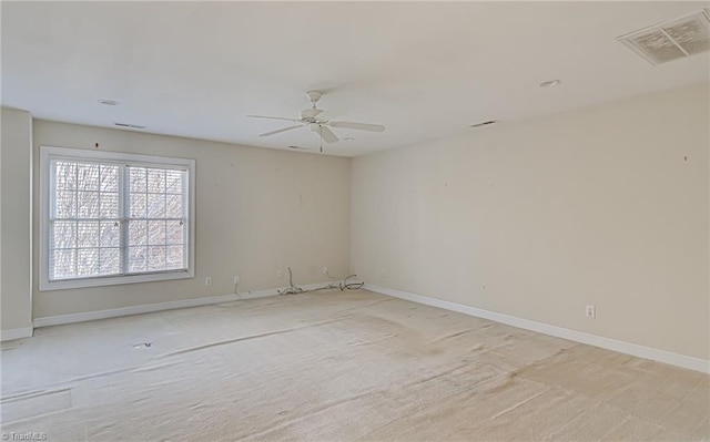 carpeted spare room with ceiling fan