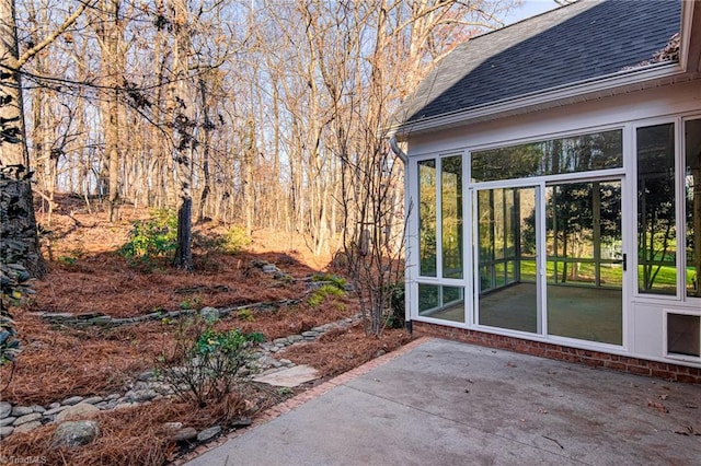 view of patio / terrace featuring a sunroom