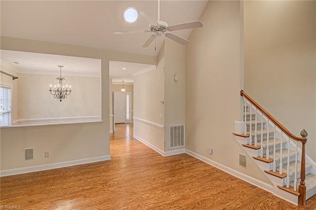 unfurnished room with light hardwood / wood-style flooring and ceiling fan with notable chandelier