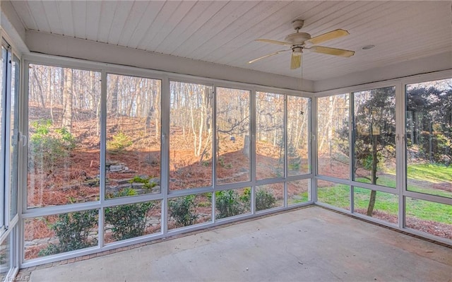 unfurnished sunroom featuring ceiling fan