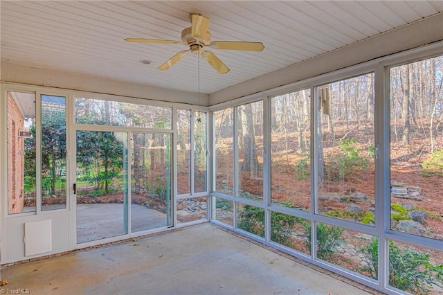 unfurnished sunroom featuring plenty of natural light and ceiling fan