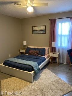 102 Aspen Ct, Winston-Salem, NC 27106 - bedroom with a ceiling fan and wood finished floors