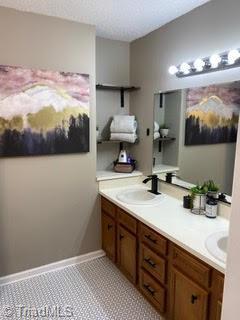 102 Aspen Ct, Winston-Salem, NC 27106 - bathroom with double vanity and a textured ceiling