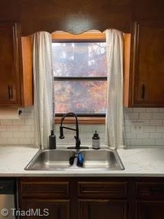 102 Aspen Ct, Winston-Salem, NC 27106 - kitchen with light countertops and decorative backsplash