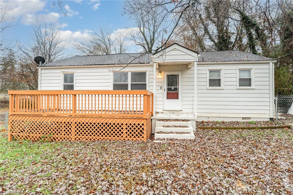 rear view of property featuring a wooden deck