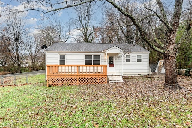 view of front of property with a deck and a front lawn