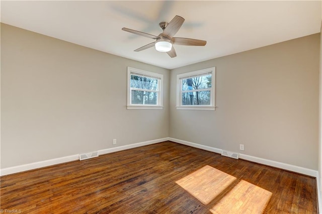 spare room featuring dark hardwood / wood-style floors and ceiling fan