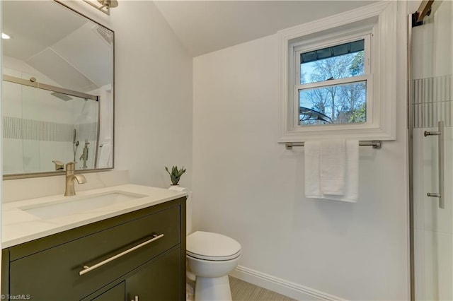 bathroom with lofted ceiling, vanity, toilet, and a shower with shower door