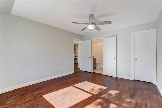 unfurnished bedroom with dark hardwood / wood-style flooring, ensuite bath, ceiling fan, and lofted ceiling