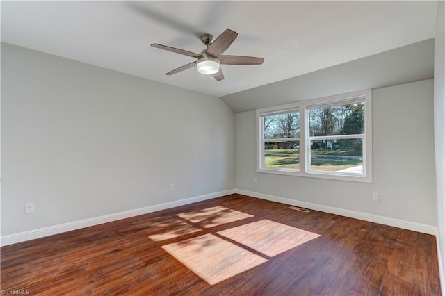 empty room featuring ceiling fan, dark wood-type flooring, and lofted ceiling