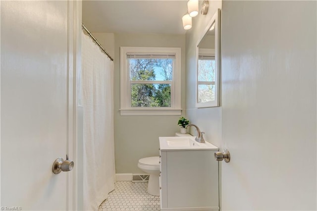 bathroom featuring tile patterned floors, vanity, and toilet