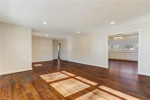 unfurnished room with dark hardwood / wood-style floors