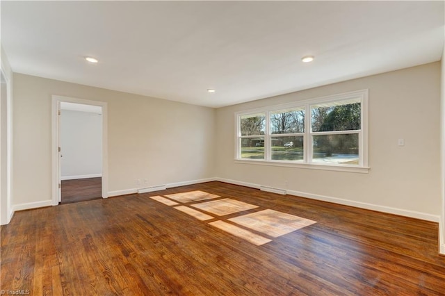 empty room featuring dark wood-type flooring