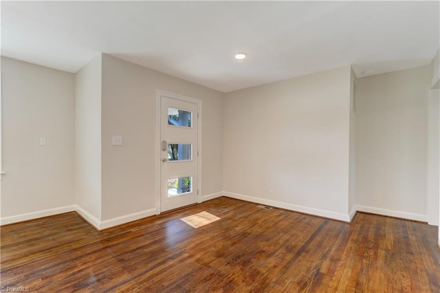 empty room with dark hardwood / wood-style flooring