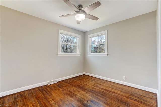 empty room with hardwood / wood-style floors and ceiling fan