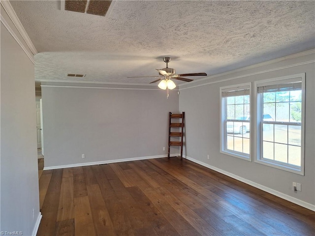 empty room featuring crown molding, visible vents, ceiling fan, and dark wood-type flooring