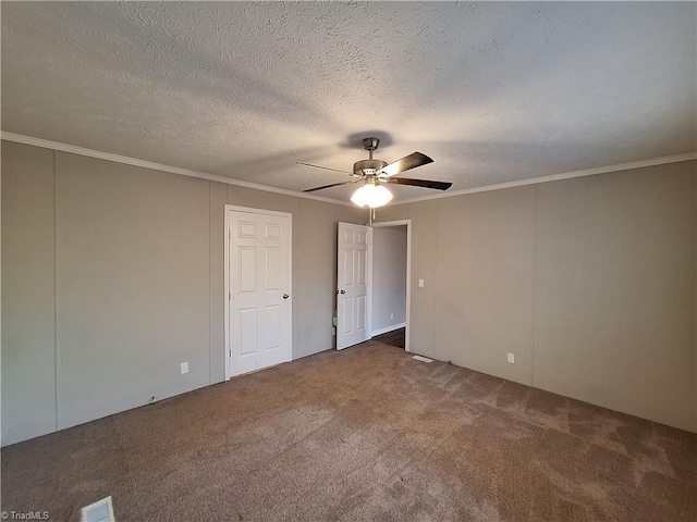 unfurnished bedroom with carpet floors, visible vents, ornamental molding, ceiling fan, and a textured ceiling