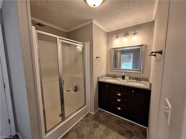 bathroom with a shower stall, ornamental molding, and a sink