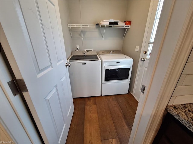 laundry room with dark wood-type flooring, laundry area, and separate washer and dryer