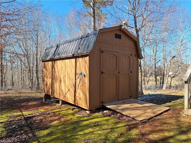 view of shed featuring fence