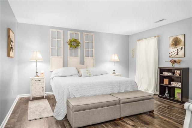 bedroom featuring wood finished floors and baseboards