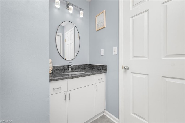 bathroom with vanity and baseboards