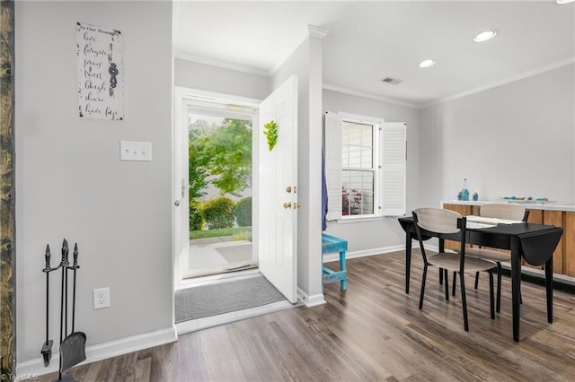 entrance foyer featuring wood finished floors, plenty of natural light, ornamental molding, recessed lighting, and baseboards