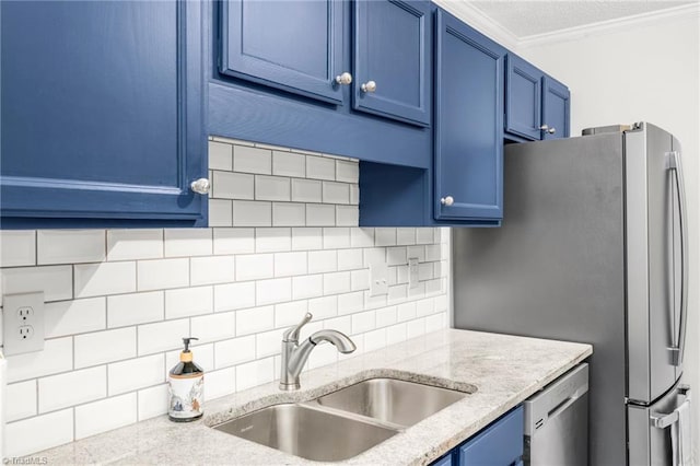kitchen featuring blue cabinetry, a sink, appliances with stainless steel finishes, decorative backsplash, and crown molding