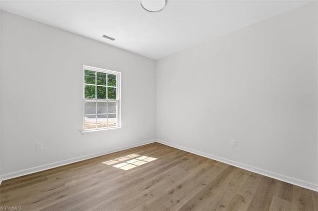 2154 E First St, Winston-Salem, NC 27101 - empty room featuring wood finished floors and baseboards