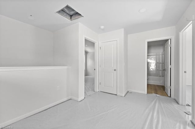 2154 E First St, Winston-Salem, NC 27101 - unfurnished bedroom featuring baseboards and ensuite bathroom