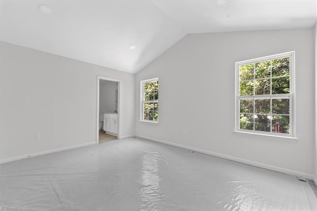 2154 E First St, Winston-Salem, NC 27101 - spare room with healthy amount of natural light, lofted ceiling, baseboards, carpet floors, and recessed lighting