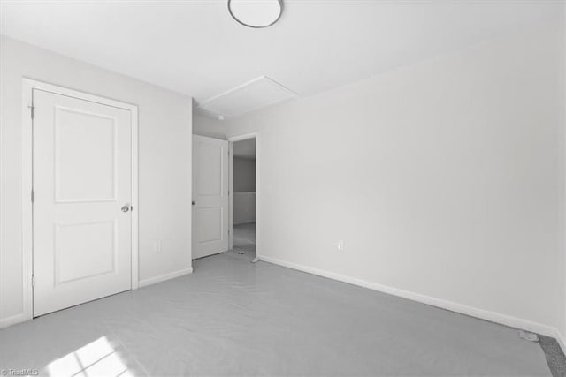 2154 E First St, Winston-Salem, NC 27101 - unfurnished bedroom with attic access, baseboards, and carpet